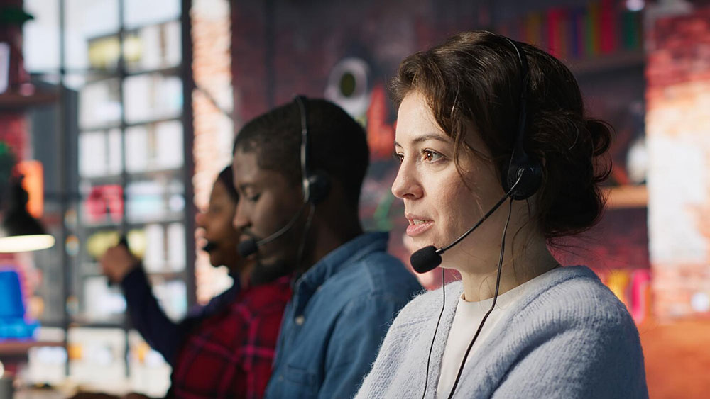 Banking contact-center agents on headsets assisting customers
